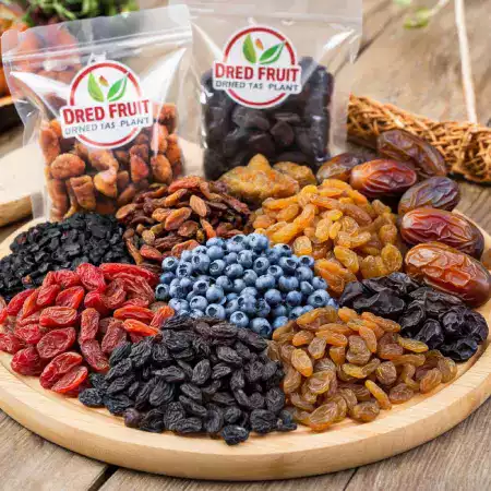 Temperature controlled storage room with stacked cartons of vacuum sealed dried fruits on wooden pallets for inventory