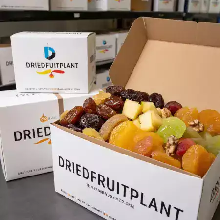 Warehouse shipping team carefully packaging dried fruit orders in corrugated boxes with protective bubble wrap for safe delivery